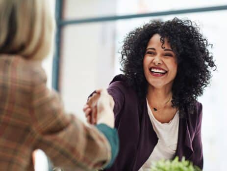 Handshake with a happy, confident business woman